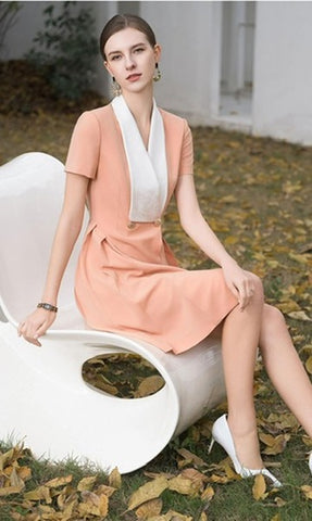 Elegant Peach Dress with Contrasting White Lapel