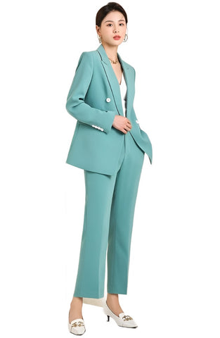 The blazer, in a stunning shade of aqua, features a classic notch lapel, complemented by a chic single-button closure that cinches the waist for a flattering silhouette
