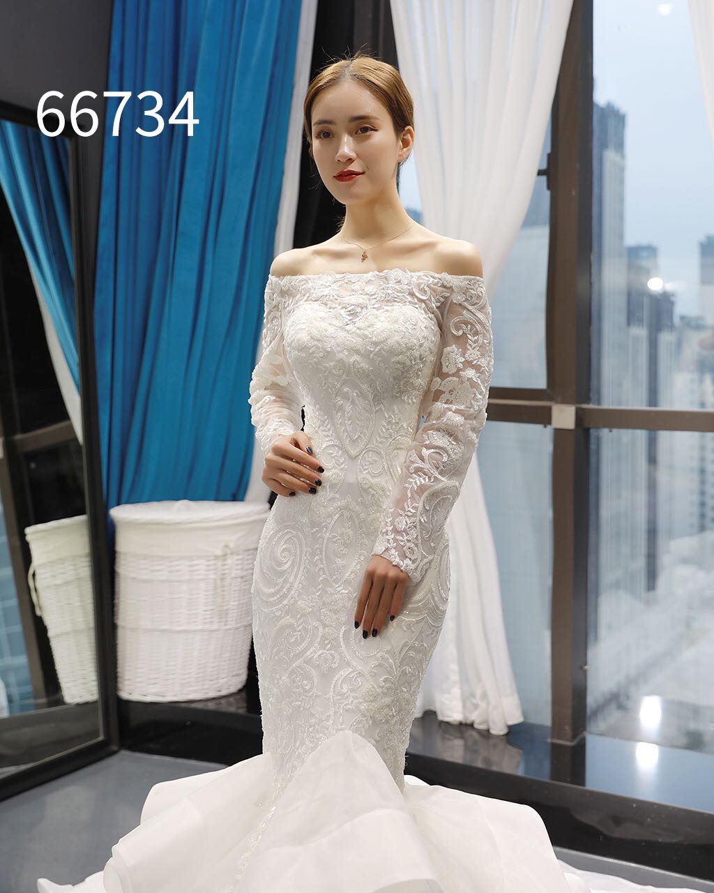 fishtail off the shoulder wedding dress Meet Andie A stunning fishtail gown with an off-the-shoulder neckline, detachable sheer sleeves, and dimensional floral appliqus at the wrist. The skirt flares into a dramatic chapel-length train- perfect for the